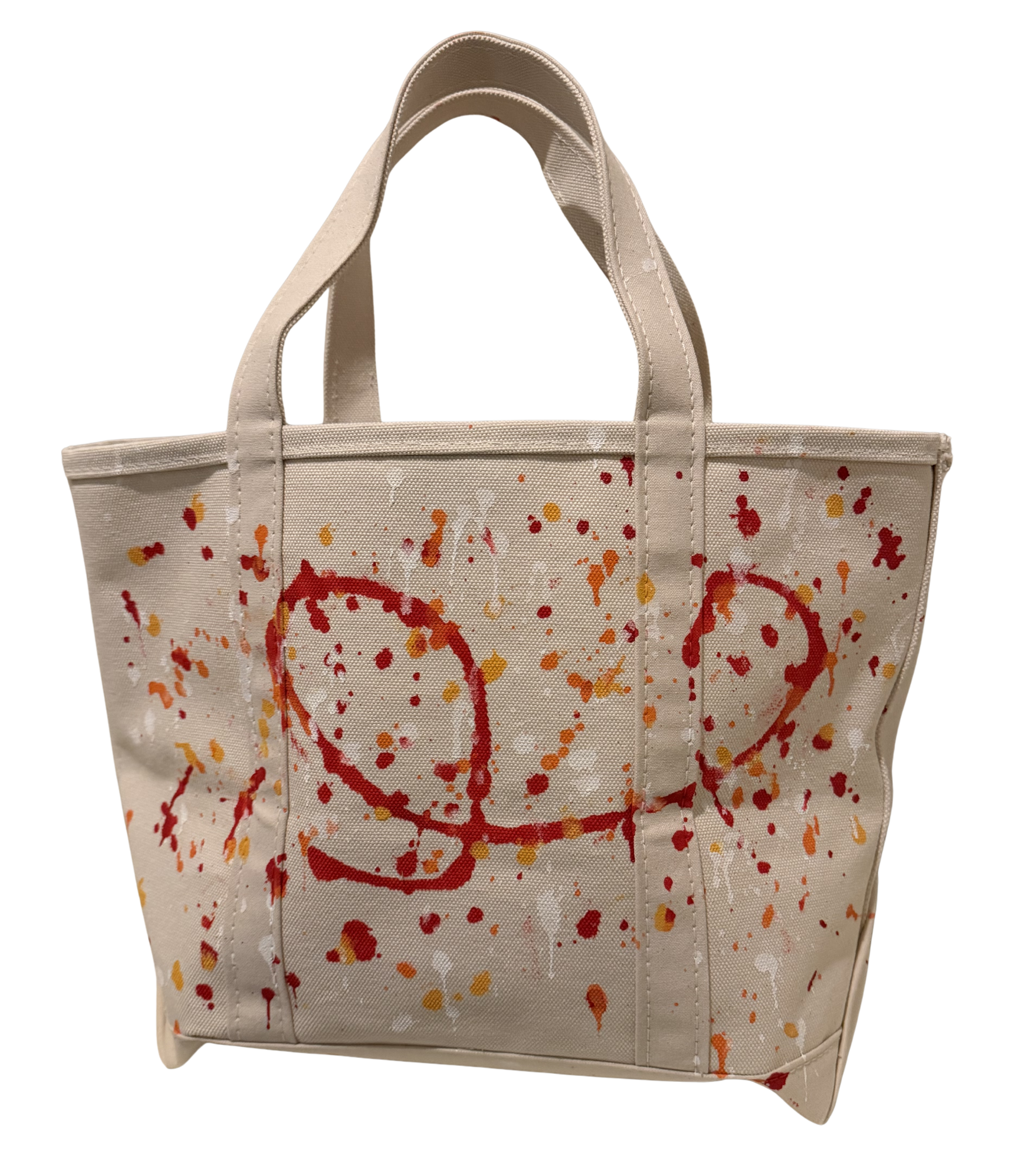 A canvas tote bag in a light beige color, decorated with red and orange paint splatters and abstract red scribbles on the front, set against a plain white background.